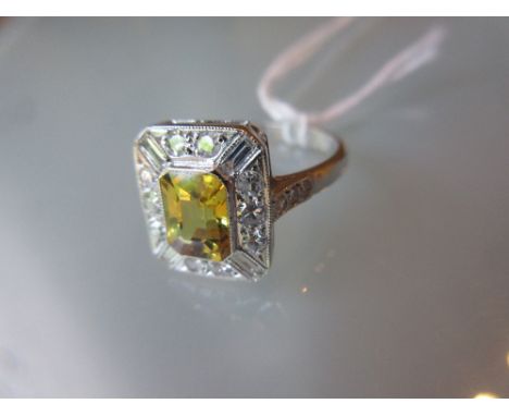 Art Deco style yellow sapphire and diamond set ring of irregular octagonal form, the central rectangular sapphire surrounded 