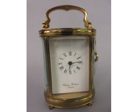 Small oval brass cased carriage clock signed Charles Frodsham, London
