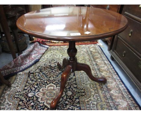 Reproduction circular mahogany pedestal table on turned column and tripod feet