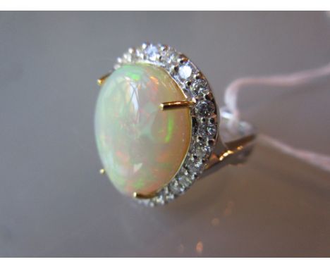 18ct White gold opal and diamond cluster ring, the pear shaped opal approximately 10.60ct