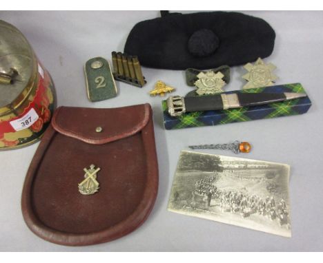 Canvas trunk containing Sutherland Highlanders uniform including: kilts, badges, boxed dirk mounted with citrine, brooch and 