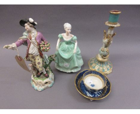 Derby figure of a gentleman and dog, No. the base 55 (at fault), together with porcelain candlestick on dragon support (at fa