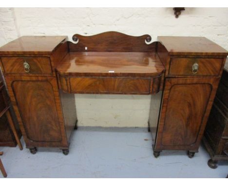 George IV mahogany and black line inlaid twin pedestal sideboard with a shaped back and rail centre, a central drawer flanked