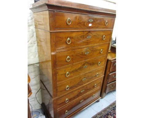 19th Century French flame mahogany chest of Empire style, the block moulded cornice above seven graduated drawers with brass 