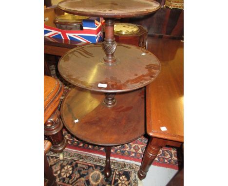 George III circular mahogany three tier dumb waiter on centre vase turned column and tripod support