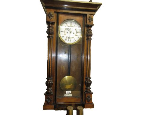 19th Century walnut Vienna wall clock, the enamel dial with Arabic numerals, with a two train weight driven movement
