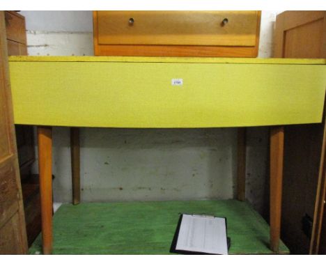 Mid 20th Century yellow Formica dining table with four similar chairs, a light oak side cabinet, two drawers above two doors,