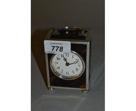 Early 20th Century silver and tortoishell cased dressing table clock having circular enamel dial with Arabic numerals, dated 