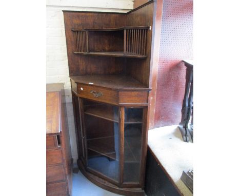 Late 19th or early 20th Century Arts and Crafts oak corner display cabinet, the open shelf top with spindle uprights, the bas