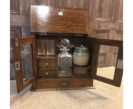 EDWARDIAN SMOKERS/DRINKS CABINETthe hinged top opening to reveal fitted interior containing drawers and tobacco jar, cut glas