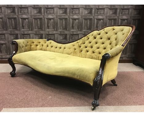 VICTORIAN MAHOGANY FRAMED DOUBLE-ENDED CHAISE LONGUEwith shaped scroll and floral carved rail, the button back upholstered in