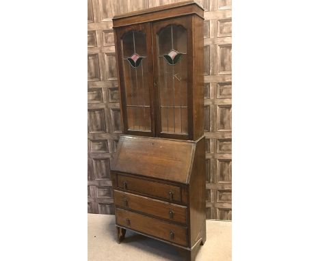 EARLY 20TH CENTURY OAK BUREAU BOOKCASEwith two arched leaded glass doors, the base with fall front writing surface enclosing 