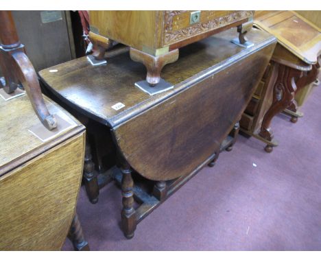 Titmarsh Goodwin Style Oak Gate Leg Table, with drop leaves on turned and block supports.