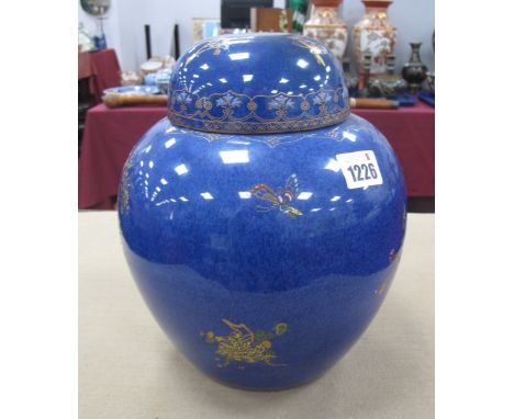 A Carlton Ware Ginger Jar, chinoiserie decorated in gilt and multi colours, featuring butterflies plus foliage, on blue lustr