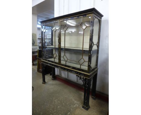 A Chinese Chippendale Revival black lacquered chinoiserie two door display side cabinet on stand 