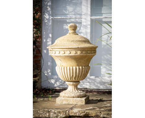 A COMPOSITION STONE LIDDED GARDEN URN  IN THE MANNER OF COADE AND SEALY, CONTEMPORARY  85cm high, 55cm diameter  Condition Re