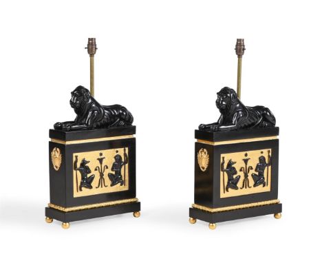 A PAIR OF EBONISED AND GILDED LAMPS   AFTER A DESIGN BY THOMAS HOPE, OF RECENT MANUFACTURE  Each utilising the sofa ends from