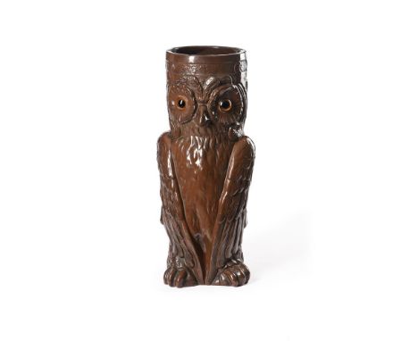 A VICTORIAN GLAZED TERRACOTTA STICK STAND IN THE FORM OF AN OWL  BY BRETBY POTTERY, LATE 19TH CENTURY  With a brown glazed bo