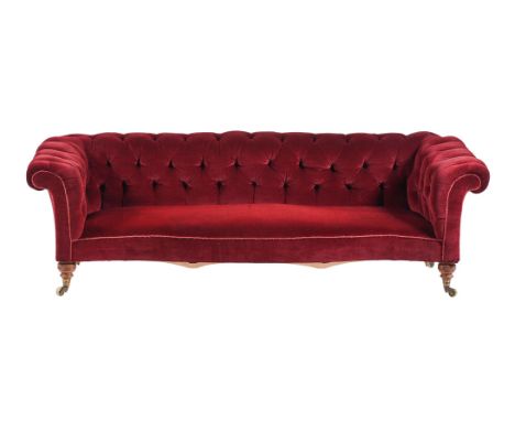 A VICTORIAN WALNUT AND BUTTONED UPHOLSTERED SOFA  BY HOWARD & SONS, LATE 19TH CENTURY The castors stamped 'HOWARD & SONS, LTD