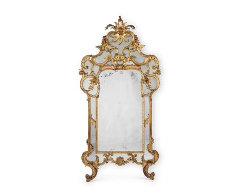 A LARGE NORTH ITALIAN CARVED GILTWOOD MIRROR  19TH CENTURY 261cm high, 132cm wide  Condition Report:  Overall there are some 