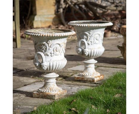 A PAIR OF CAST IRON CAMPANA URNS  ATTRIBUTED TO THE HANDYSIDE FOUNDRY, 19TH CENTURY   Cast with foliage  60.5cm high, bases 2