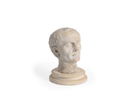 AFTER THE ANTIQUE, A CARVED MARBLE HEAD OF AN EMPEROR PROBABLY ITALIAN, EARLY 19TH CENTURY Now set on associated circular pli