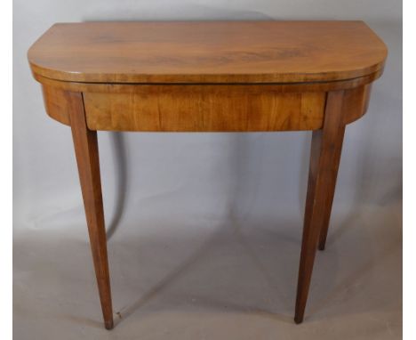 A 19th Century Mahogany Card Table with a baize lined interior above a frieze drawer raised upon square tapering legs