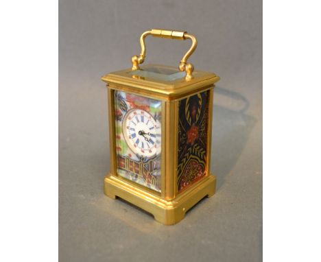 A Brass Cased Miniature Carriage Clock with Imari porcelain panels and circular enamel dial, with visible lever escapement, 7