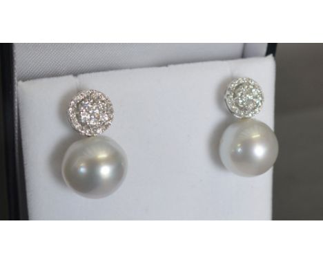 A Pair of 18ct. White Gold Pearl and Diamond Drop Earrings, approximately 1 ct