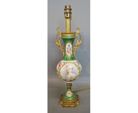 An Early 20th Century French Porcelain and Gilt Metal Table Lamp, hand painted with a reserve depicting a classical figure up