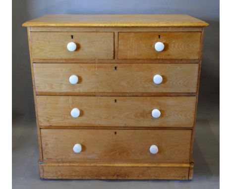 A 19th Century Pine Chest of Two Short and Three Long Drawers with Ceramic Handles raised upon a plinth, 106 cms wide