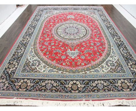 A North West Persian Woollen Carpet, with a central medallion within an all over design upon a red, blue and cream ground wit