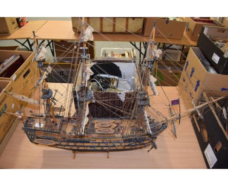 A scale model of a triple-masted ship together with a group of nautical items including a bulkhead clock, ships lantern, bosu