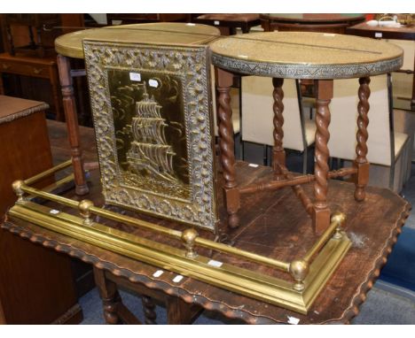 Two brass top circular Eastern tables with folding stands; brass firescreen and a brass fire curb 