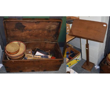 An iron bound trunk containing painted snare drum, dolls cradle, childs accordion etc