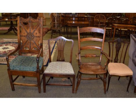 An elm country open arm chair with ladder back, a George III mahogany dining chair, an Edwardian mahogany dining chair and an