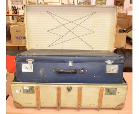 A wooden bound travelling trunk bearing old shipping labels; and a blue suitcase (2)
