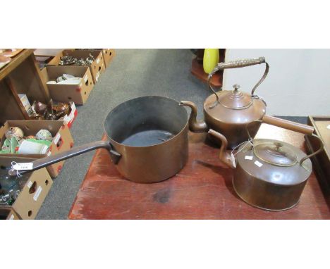 Two similar vintage copper kettles, together with a heavy copper cooking pot or pan with iron handle. (3)(B.P. 21% + VAT) 