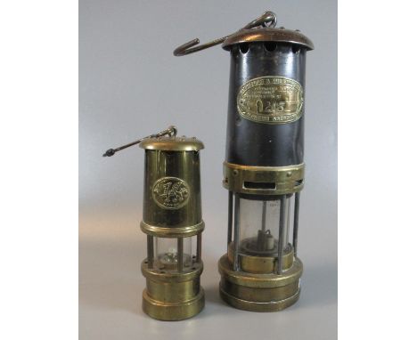 Thomas & Williams of Aberdare brass miner's safety lamp in used condition, together with a reproduction Welsh brass miner's s