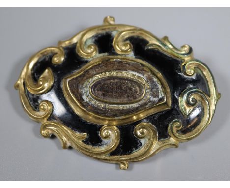 A Victorian mourning brooch decorated in black enamel with locket section to the front. Dated 1859.(B.P. 21% + VAT) 