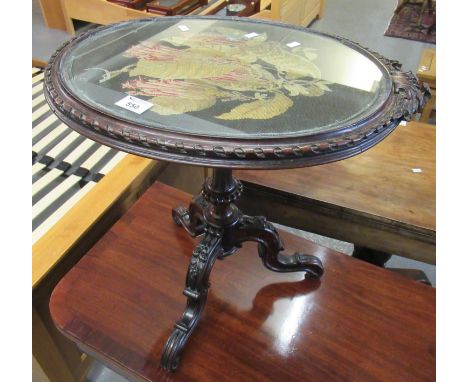 19th Century stained walnut tripod glass top tapestry decorated table of oval form. (B.P. 21% + VAT)&nbsp;No serious damage. 