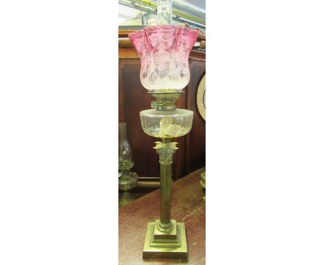 Early 20th Century double oil lamp having clear glass chimney, cranberry frosted and etched glass floral and foliate shade, a