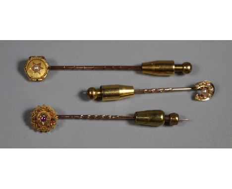 Two pearl set stick pins and a red stone stick pin.(B.P. 21% + VAT) 