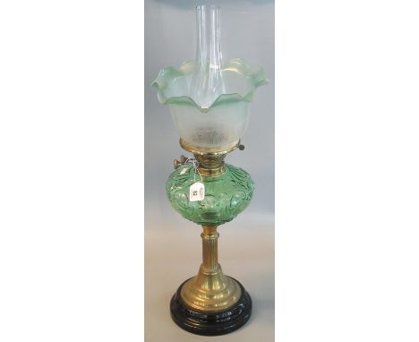 Early 20th Century double oil  lamp having clear glass chimney, green and frosted etched glass shade, above a green moulded f