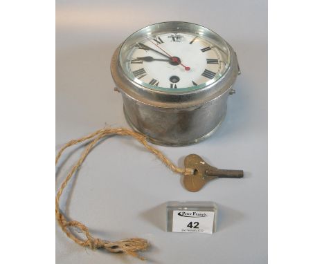 Plated metal bulkhead clock with enamelled Roman face having sweep seconds hand. With key. 3.5cm diameter approx.(B.P. 21% + 