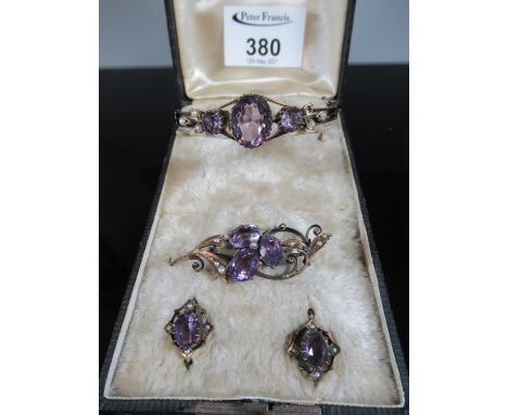 A Victorian suite of amethyst and seed pearl set jewellery comprising bangle, brooch and earrings.  Set in silver gilt.(B.P. 