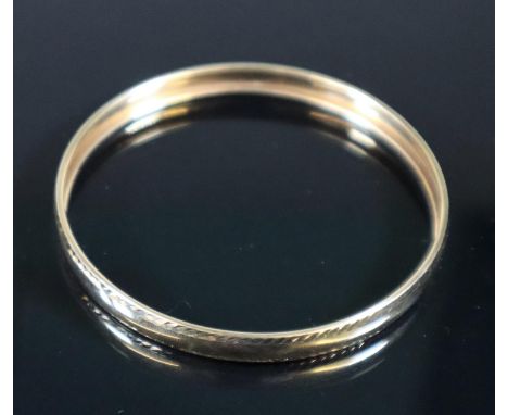 9ct gold bangle with feathered detail.  Approx weight 6 grams.(B.P. 21% + VAT) 