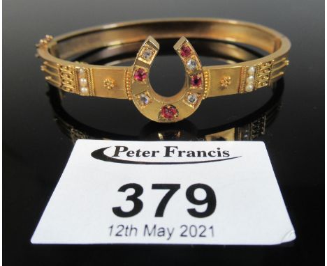 Victorian 15ct gold horse shoe bangle set with diamonds and rubies. Approx weight 13.5 grams. (B.P. 21% + VAT)condition is go