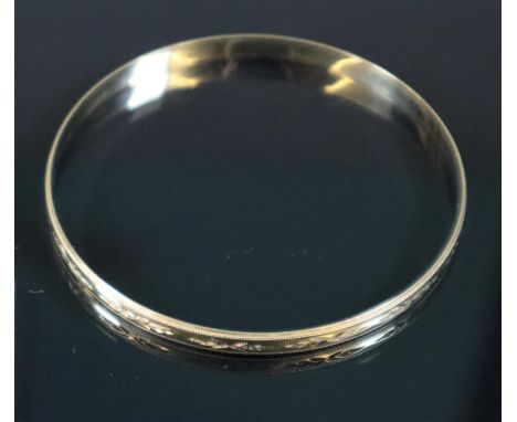 9ct gold engraved bangle.  Approx weight 7.3.(B.P. 21% + VAT) 