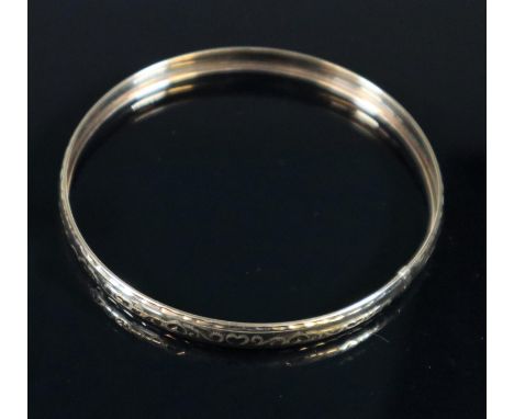 9ct gold engraved bangle.  Approx weight 4 grams.(B.P. 21% + VAT) 